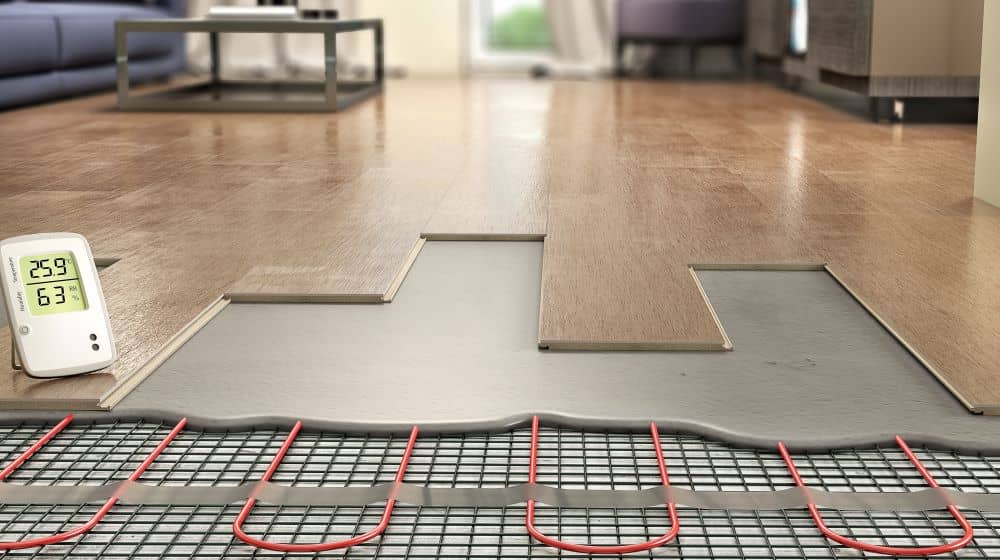 Underfloor heating system installed under laminate planks is a form of On Slab installation.
