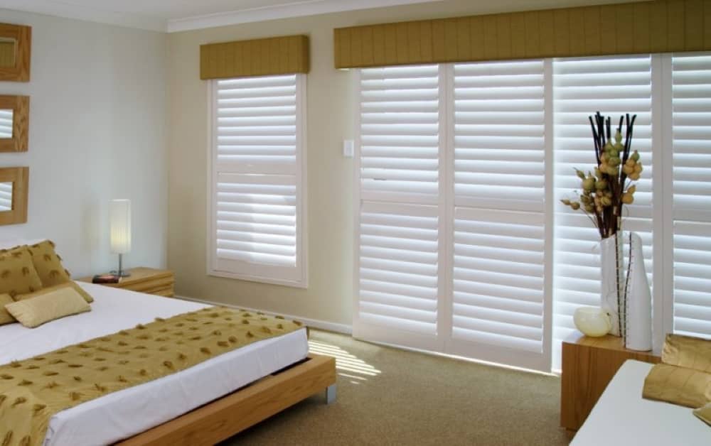 Sliding plantation shutters, faux wood.