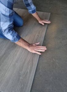 Tapping planks to snap together.
