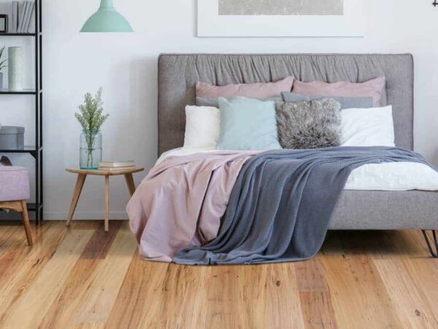 Modern bedroom with engineered timber flooring.