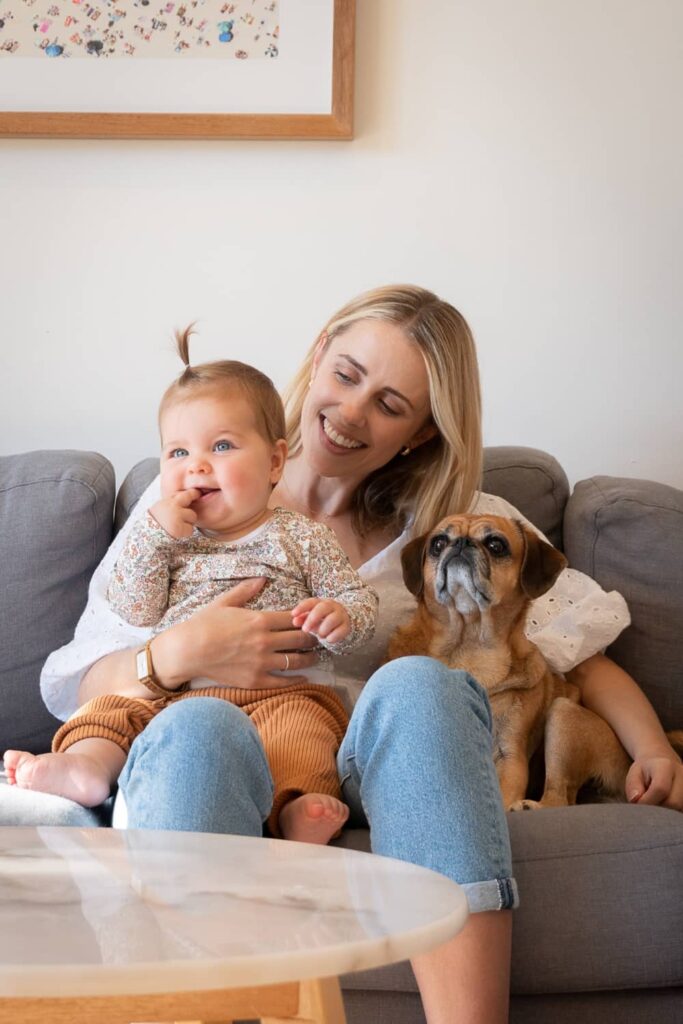Cat Sikora at home with her baby and her dog.