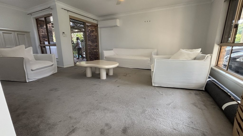 Before: low quality carpet in the formal living room